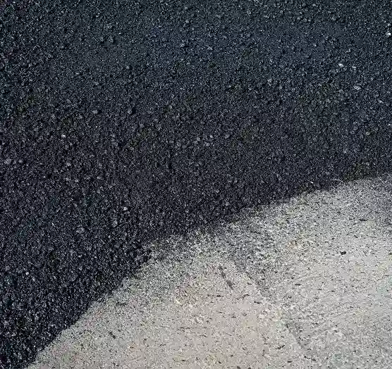 Freshly installed asphalt paving on commercial roadway