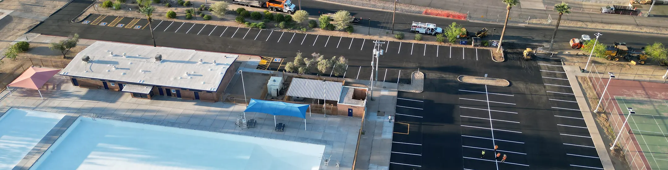 Aerial view of new parking lot by community center and pool in Arizona