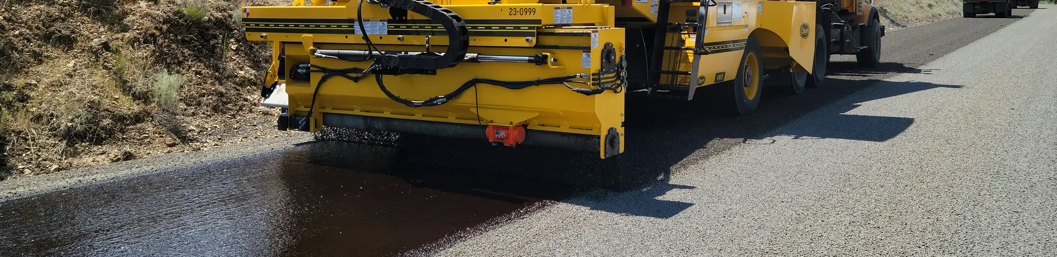 Asphalt paving machine laying a fresh roadway surface with a compacted finish in Phoenix, Arizona