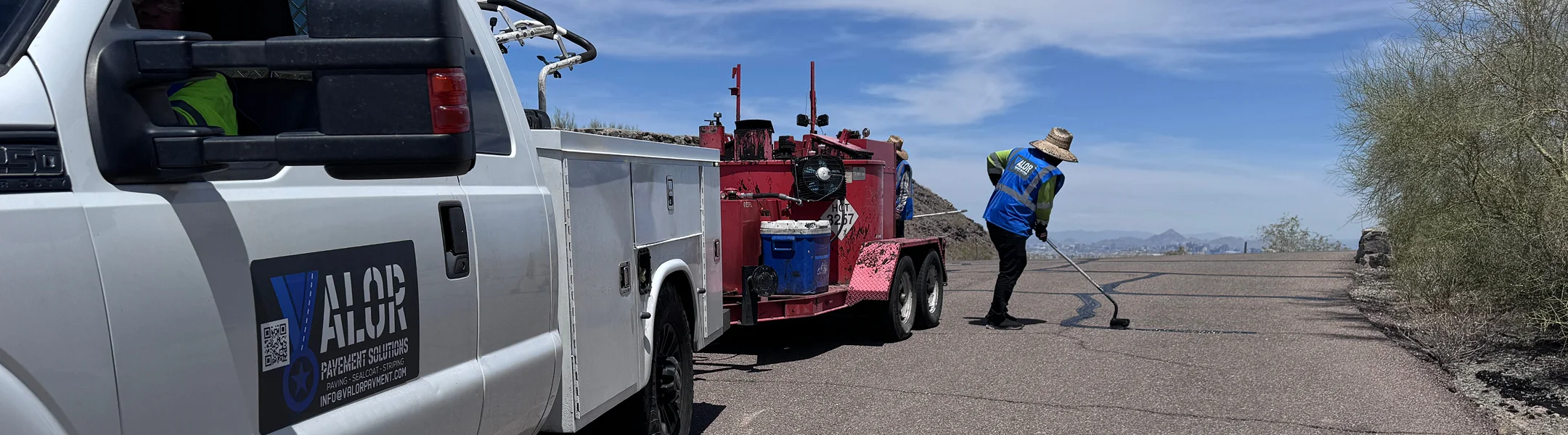 Valor Paving crew setting up roadside equipment in Arizona desert