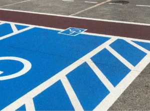 Freshly painted handicap parking space with ADA-compliant blue and white striping.