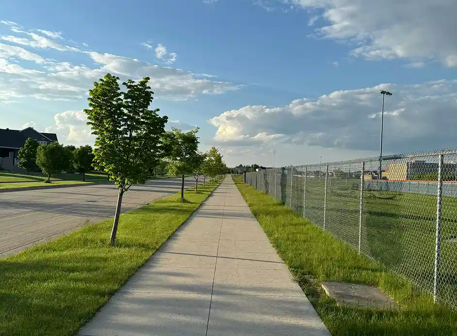 Durable paved walkways for commercial and public spaces with green grass and sidewalk.
