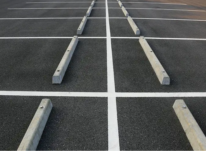 Empty parking lot with new striping and concrete wheel stops