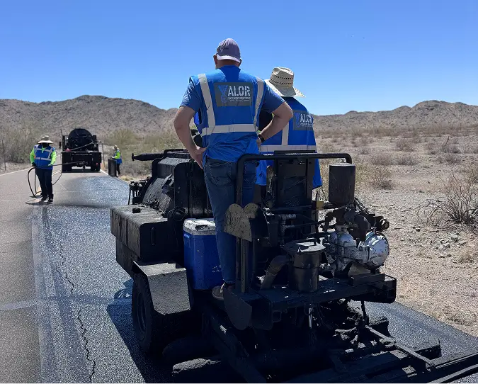James Wolfenden’s team applying asphalt pavement treatment in the Arizona desert, demonstrating Valor Pavement Solutions’ commitment to high-performance and reliable results.