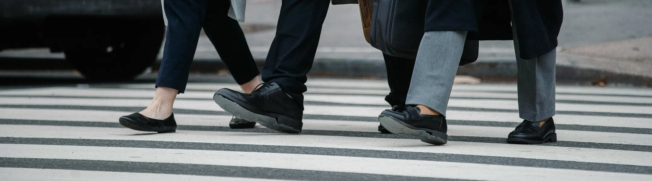 People walking across a crosswalk representing urban infrastructure in Phoenix, Arizona