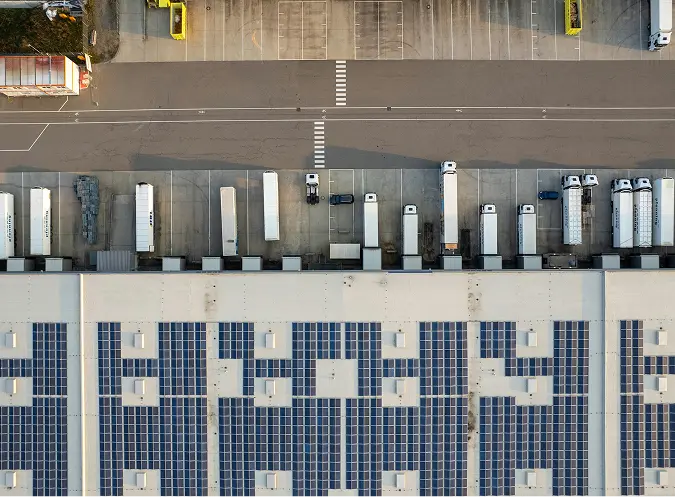 Aerial view of loading zone with multiple cargo trucks at a distribution center in Arizona paved by Valor Pavement Solutions