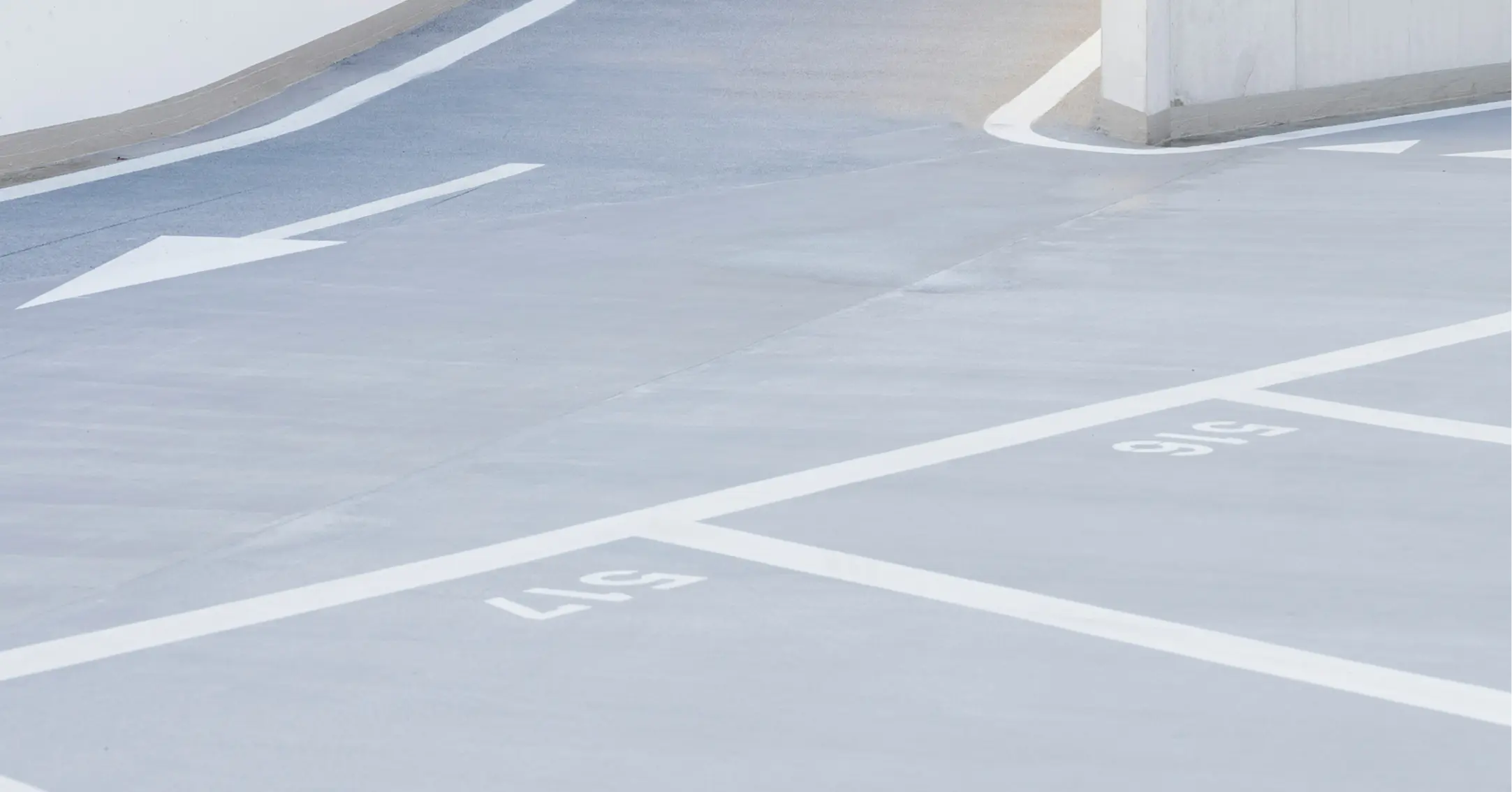 Arrow-marked asphalt surface showing directional flow in parking area