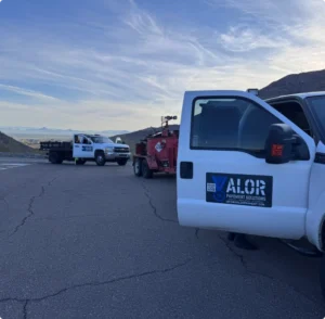 Valor Paving trucks and equipment preparing asphalt paving for a retail business in Arizona