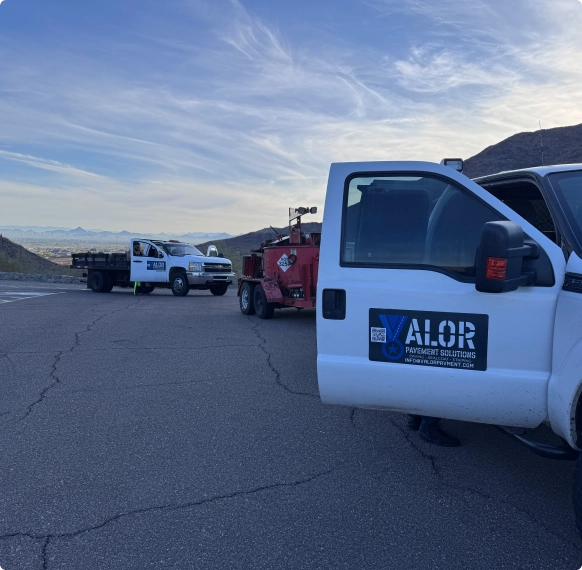 Valor Paving trucks and equipment preparing asphalt paving for a retail business in Arizona