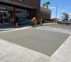 Crew smoothing freshly poured concrete during a parking lot flatwork repair at QuickTrip in Chandler, AZ.