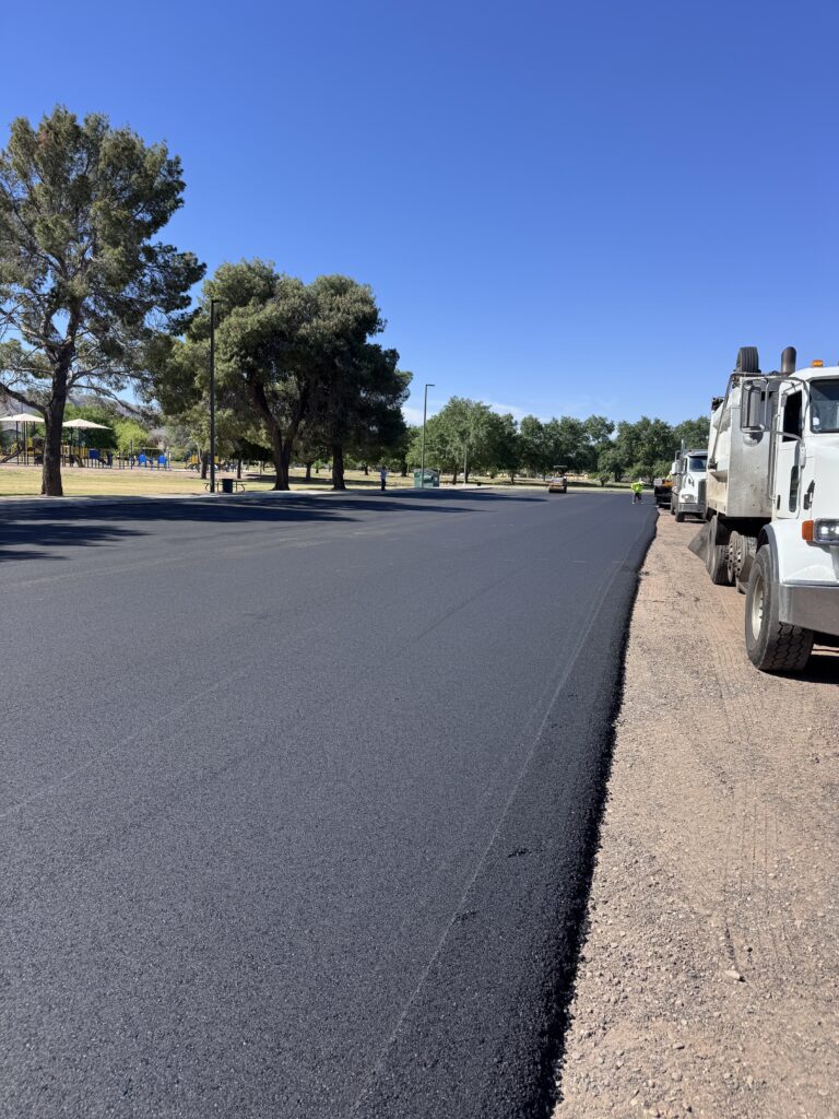 Paving crew laying fresh asphalt at El Prado Park for the City of Phoenix