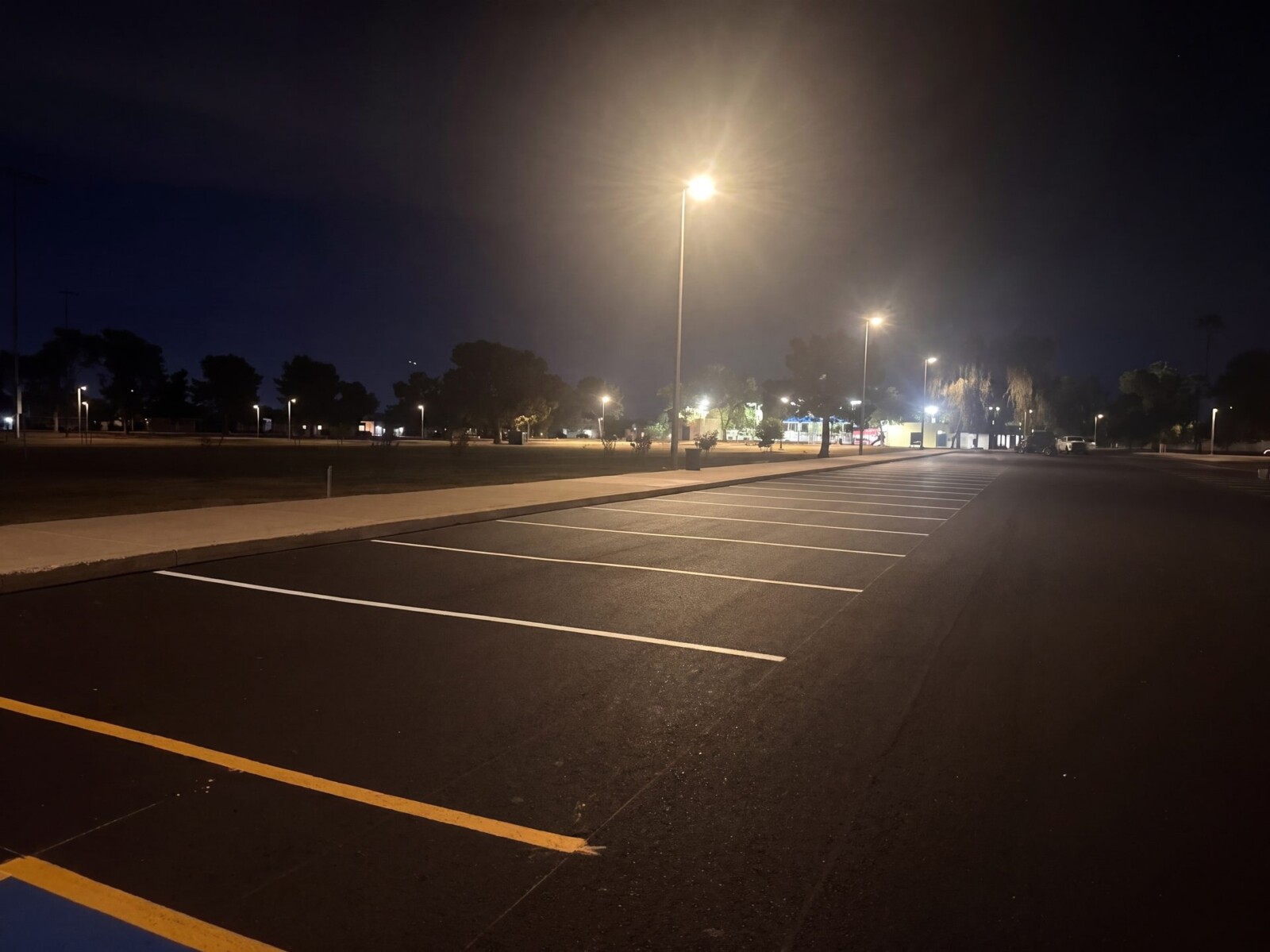 Completed asphalt paving at El Prado Park showing clean surface and curbing