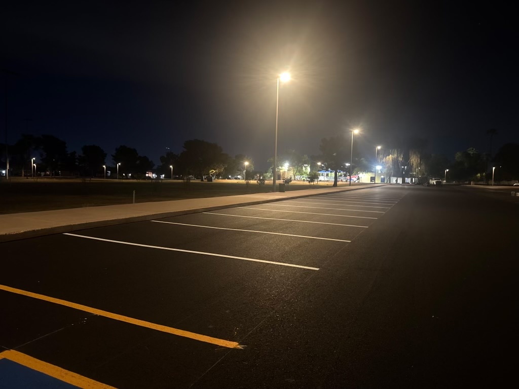 Completed asphalt paving at El Prado Park showing clean surface and curbing