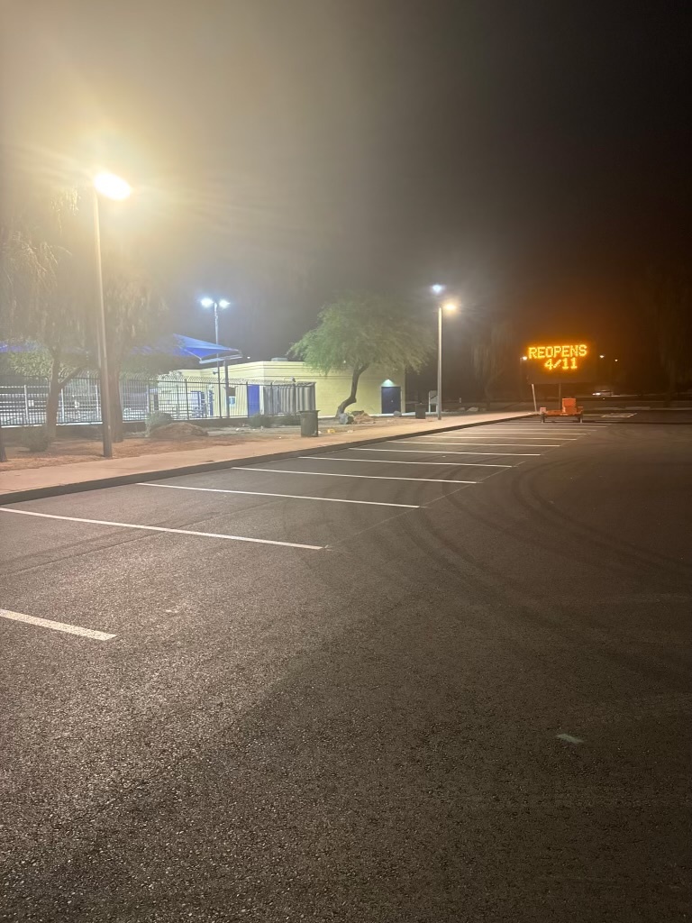 Completed paving project at El Prado Park with REOPENS sign visible