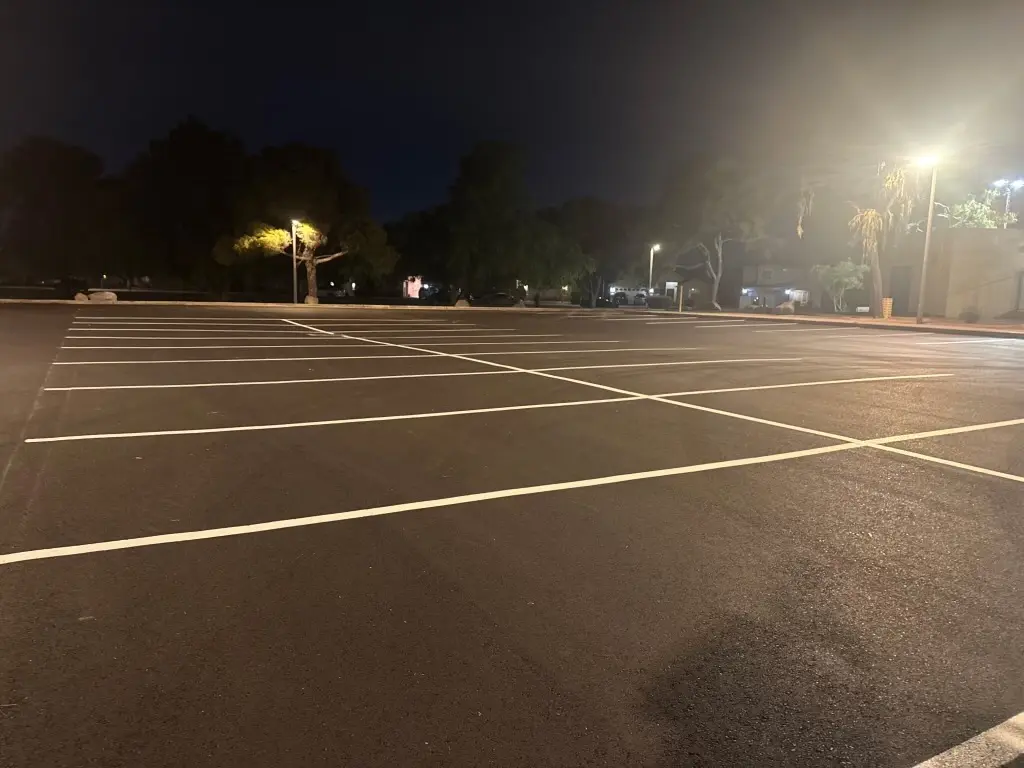 Finished El Prado Park parking lot at night with fresh parking stall striping