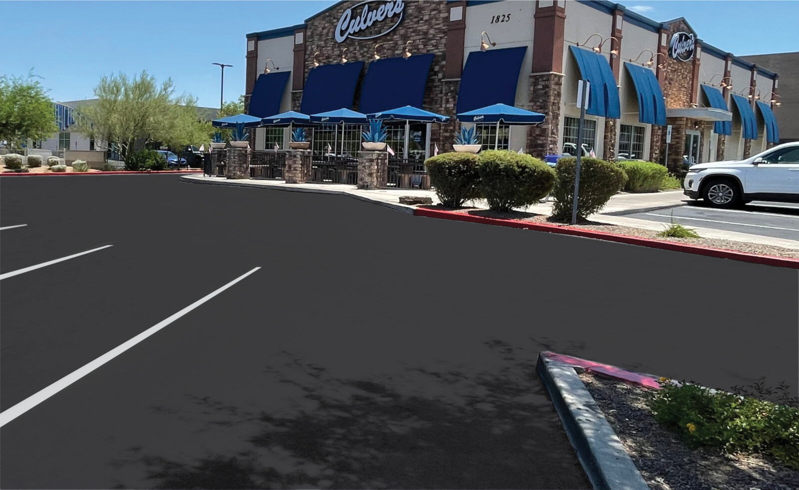 Sealcoated customer parking lot with fresh white stall striping at Culver's in Phoenix