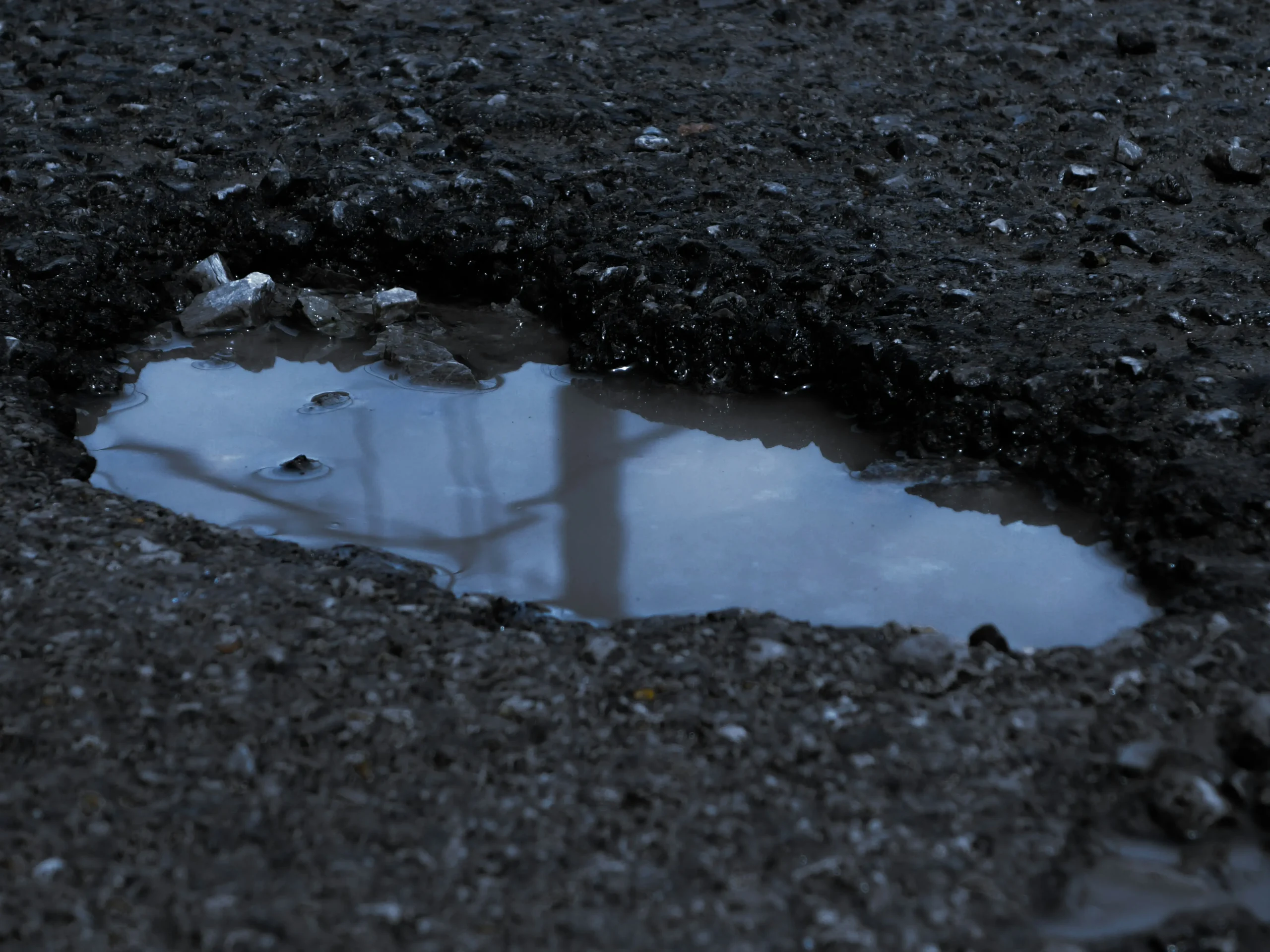 Pothole in a Phoenix commercial parking lot after monsoon season